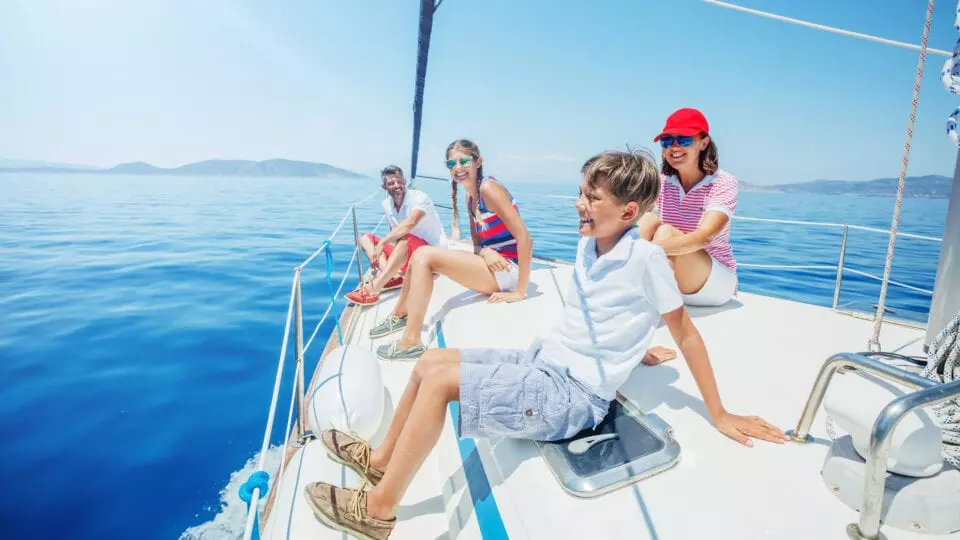 Smiling family on a sailboat