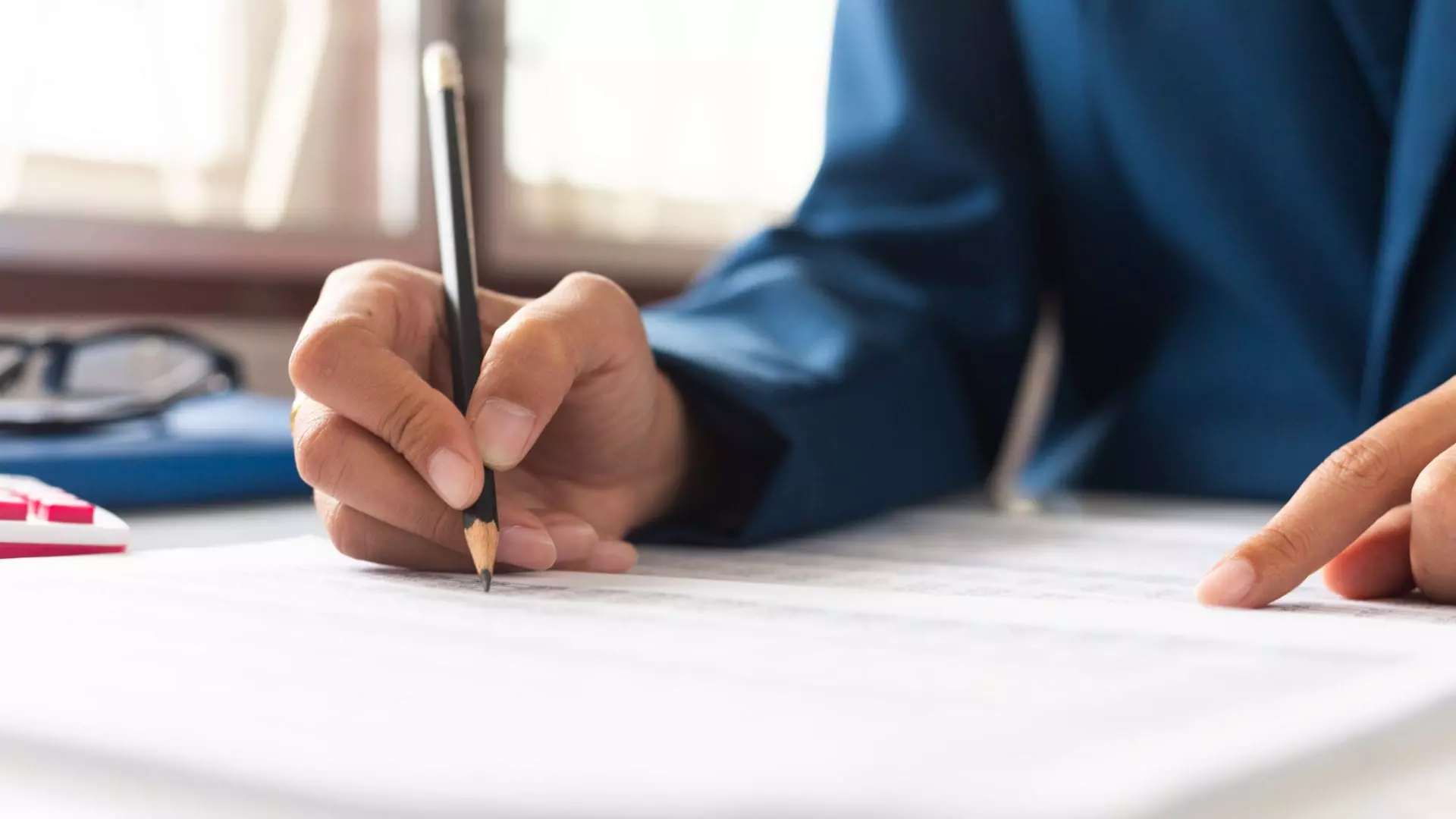 Man writing with pencil