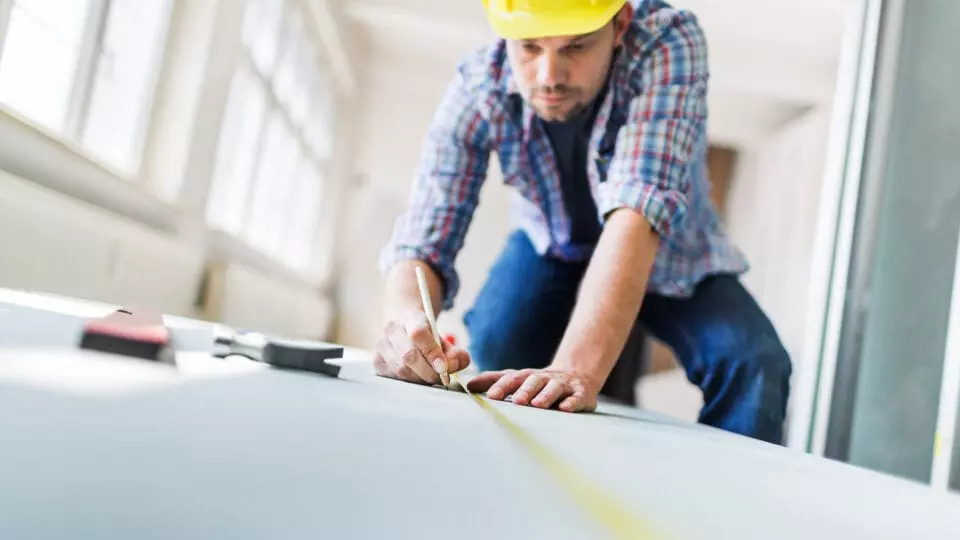 Construction worker writing with a pencil