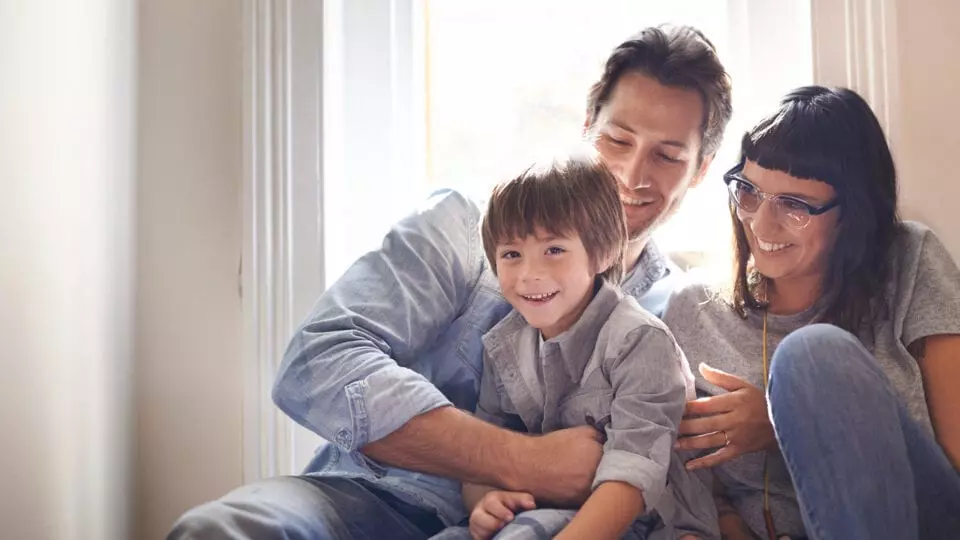 Couple and their son smiling and having fun