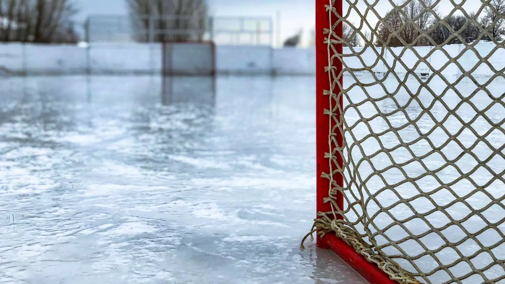 Ground level view of Hockey nets sitting on ice rink