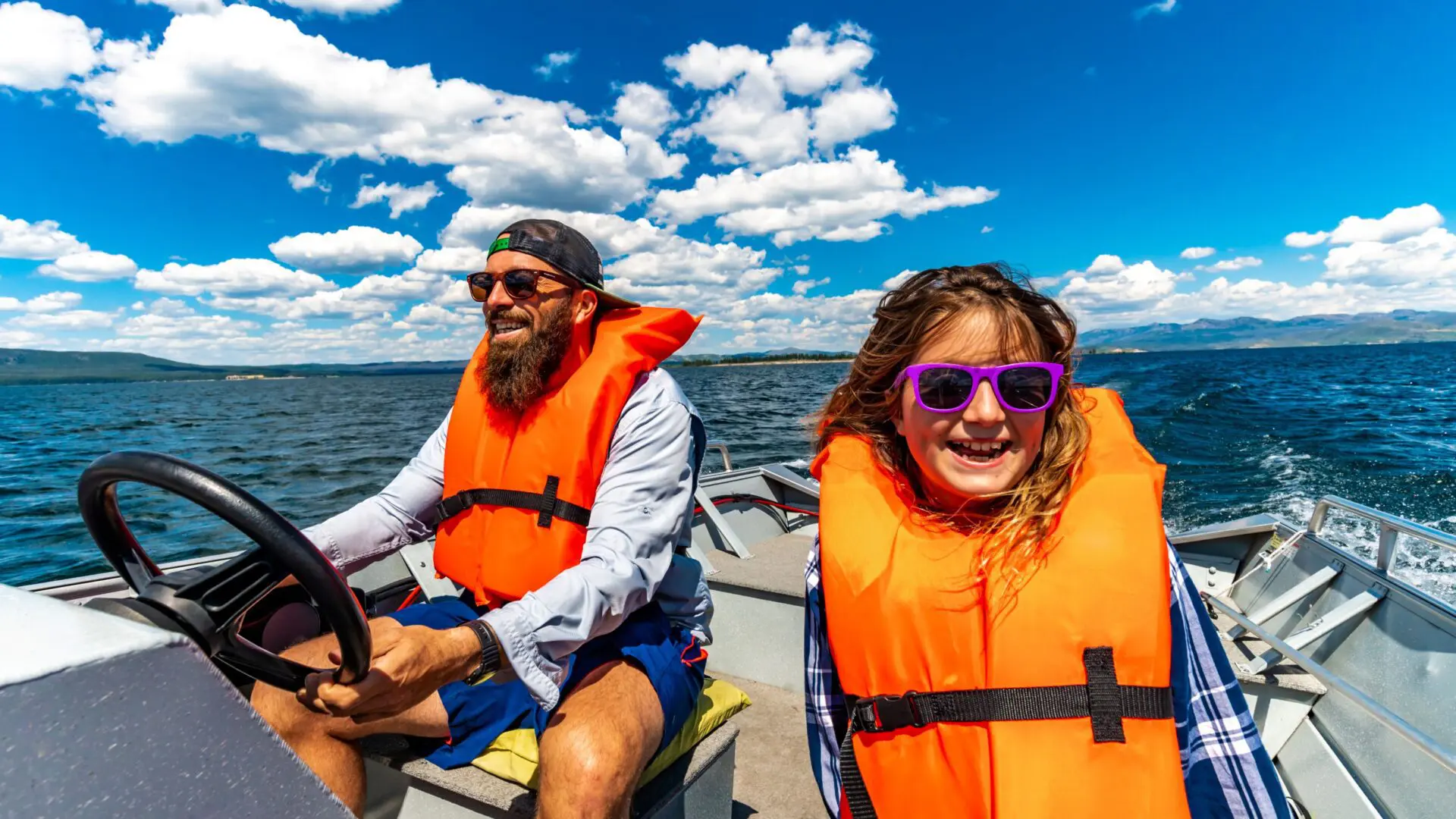 father and daughter on a boat wearing life jackets