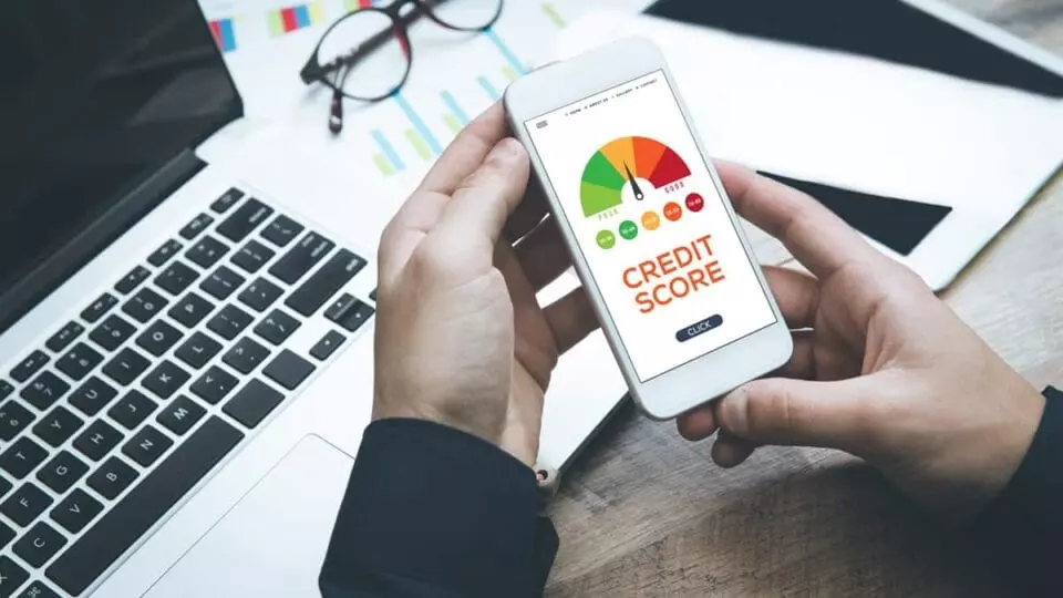 a person looking at their credit score on their mobile phone