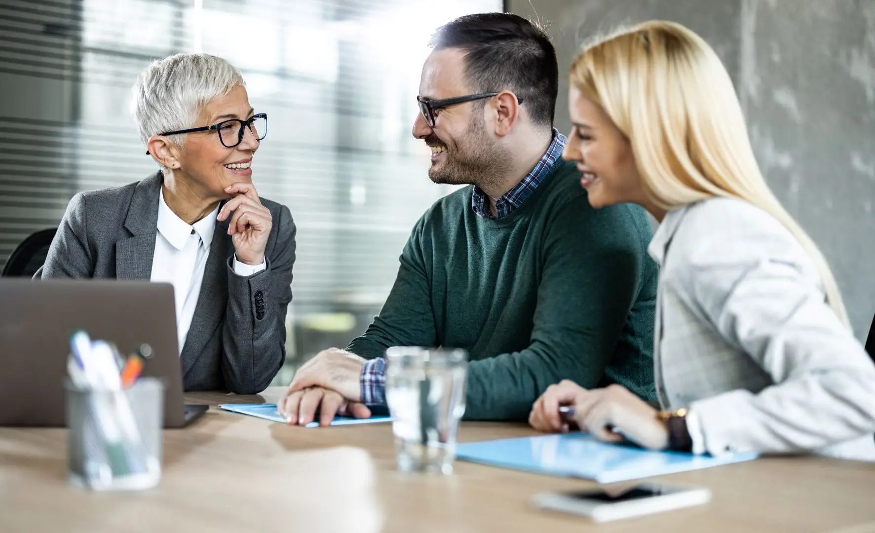 Couple discussion critical illness insurance with an advisor