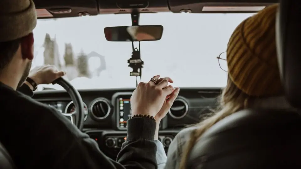couple driving and holding hands