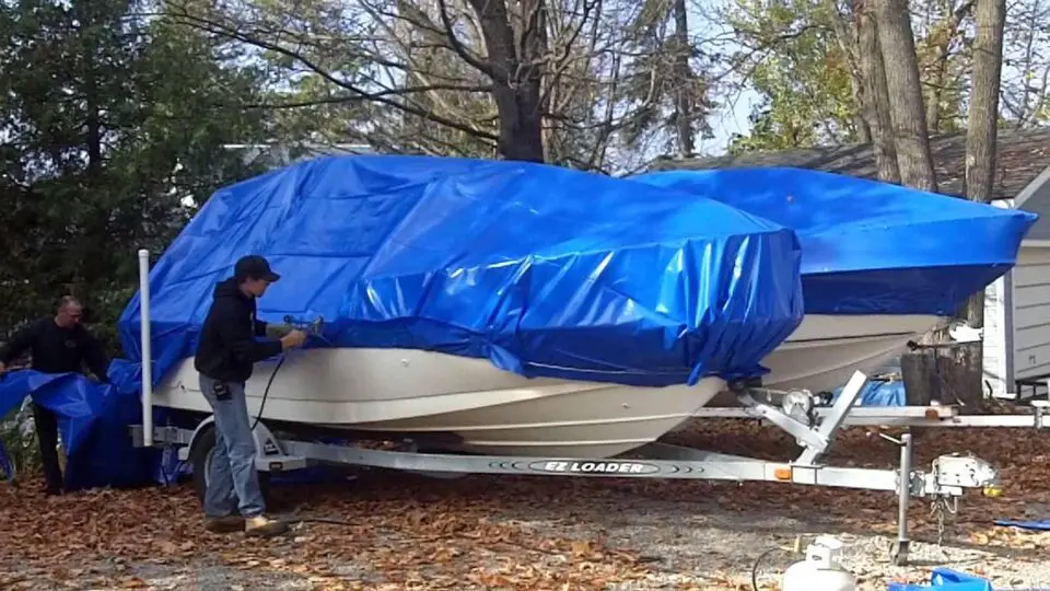 Man preparing a boat for winter