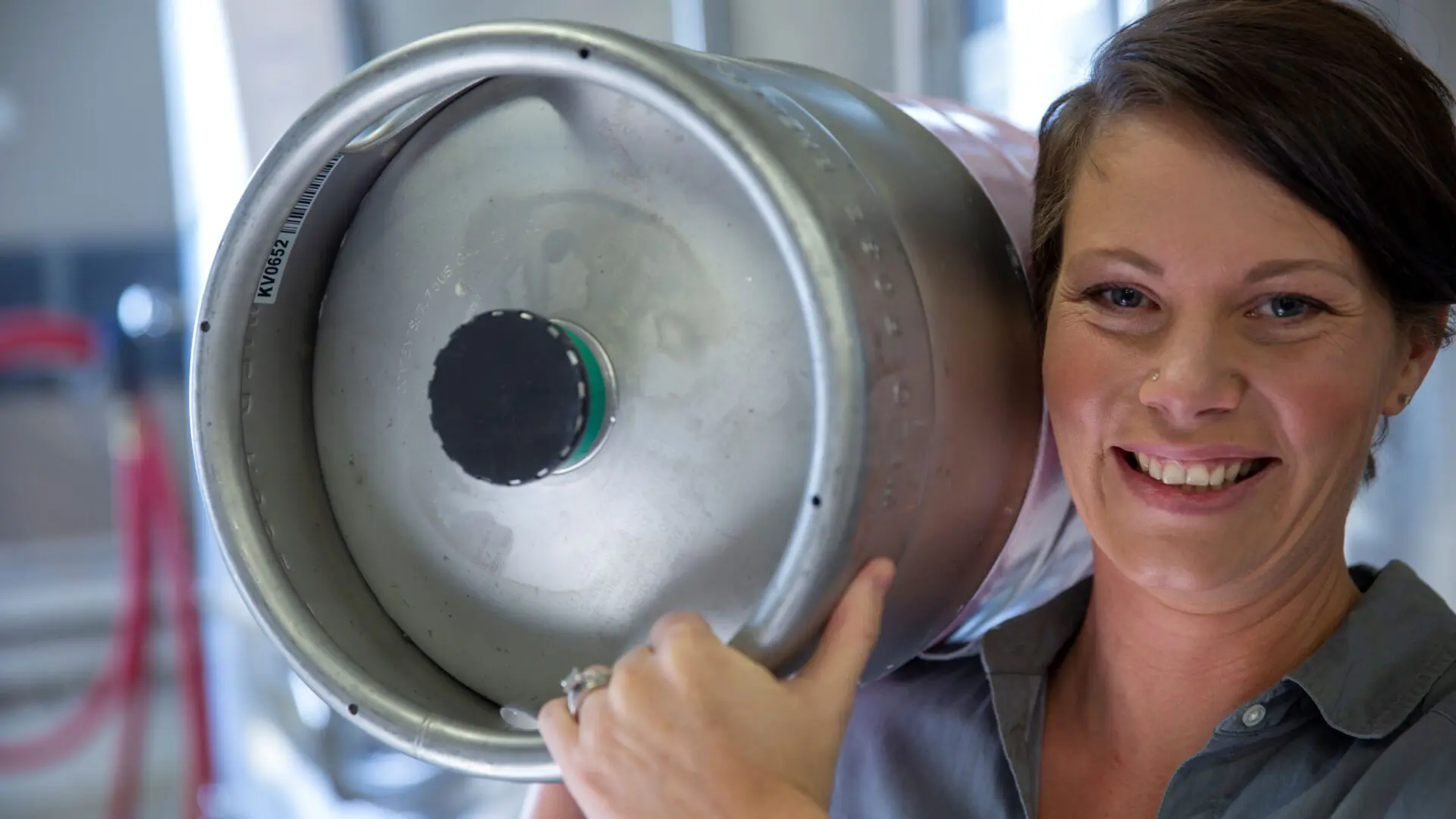 Craft brewery employee holding a beer canister