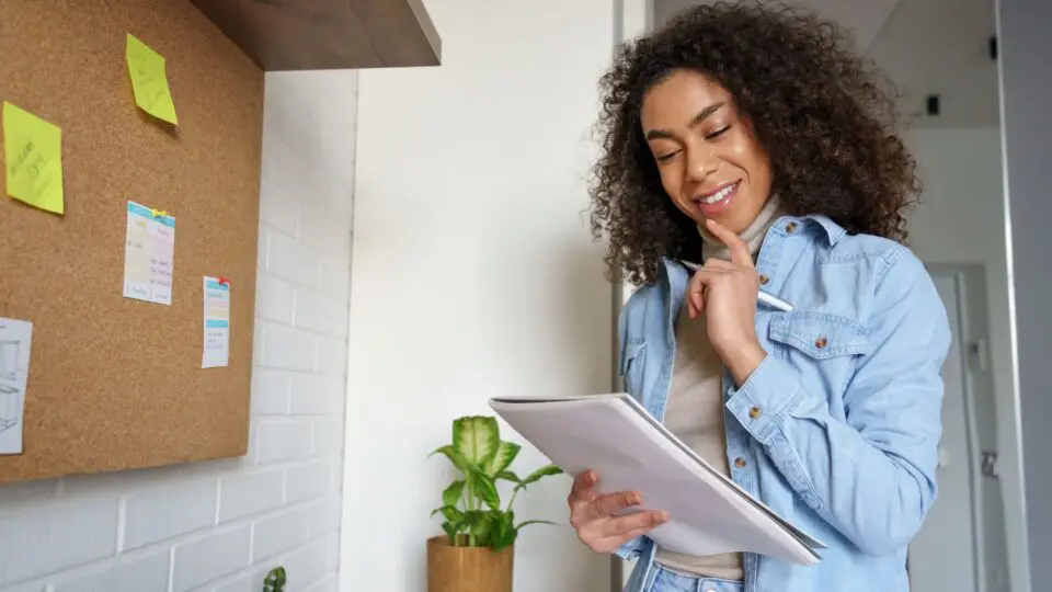 Female looking at a note pad.