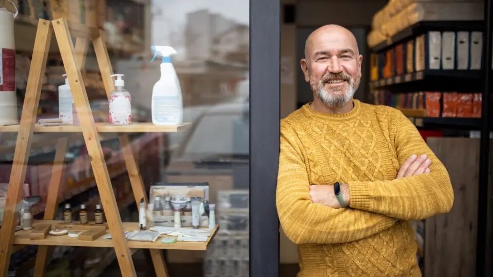 Image of a small business owner in front of his shop