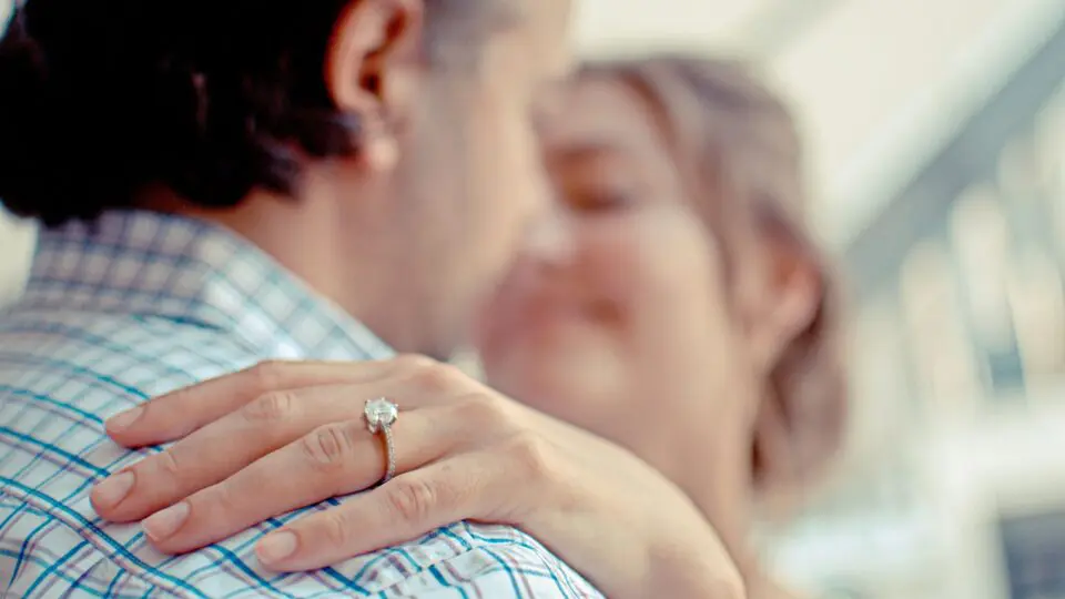Woman embracing her partner after receiving a ring