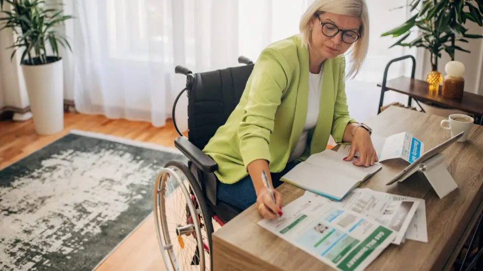 female in a wheelchair working at a home office