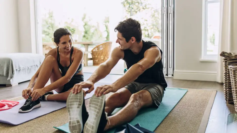 A couple streching in their apartment