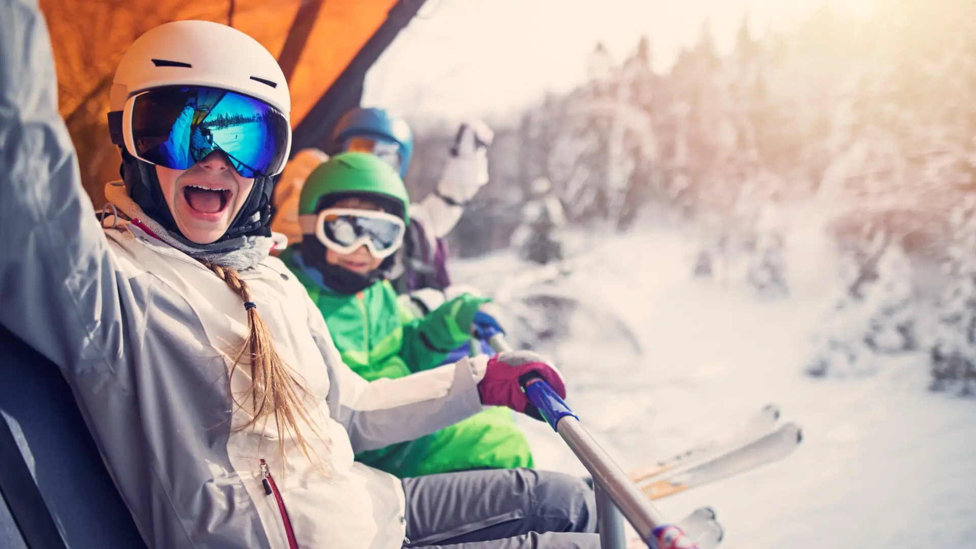 A family on a ski chair lift enjoying a vacation