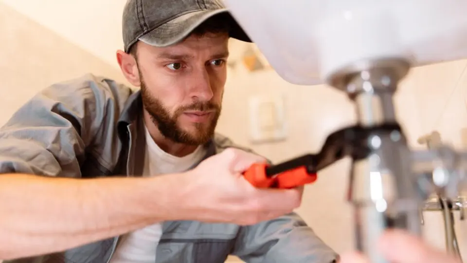 Plumber installing pipes for a sink