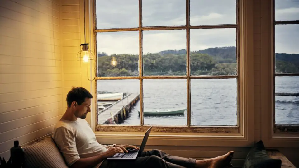 Man on his laptop in his Maritime home