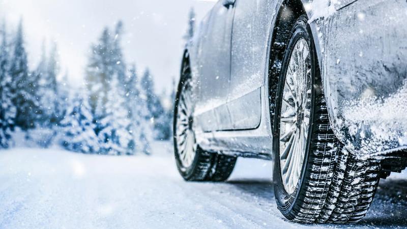 Car with winter tires driving in snowy conditions