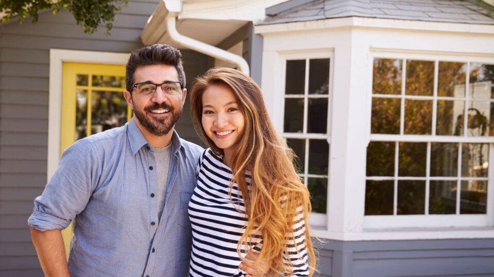 couple in front of their home