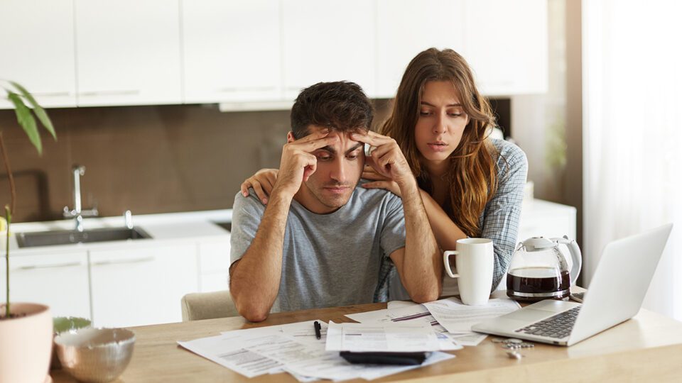 Couple reviewing a complicated mortgage insurance policy
