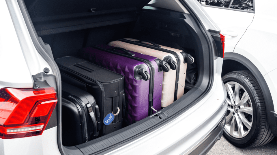 image of suitcases packed in the trunk of a car