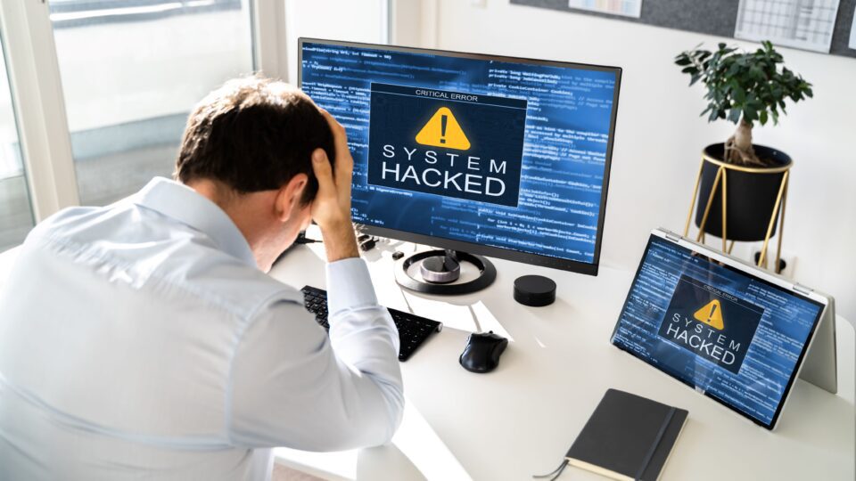 Man realizing that his computer has been hacked