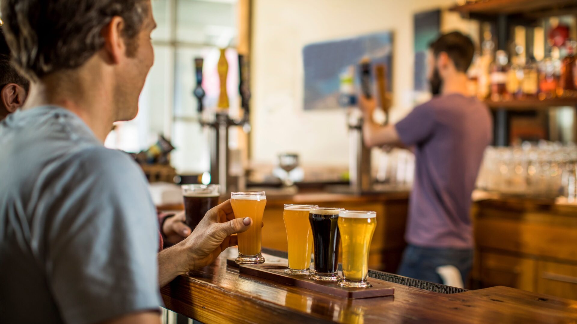 craft brewery employee pouring a drink for a customer