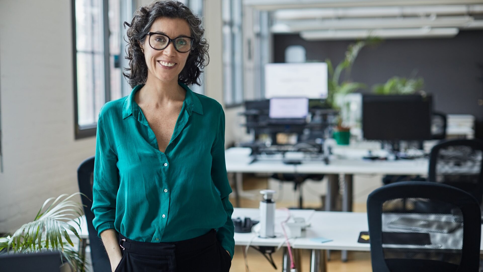 A female small business owner at her offices before her employees arrive