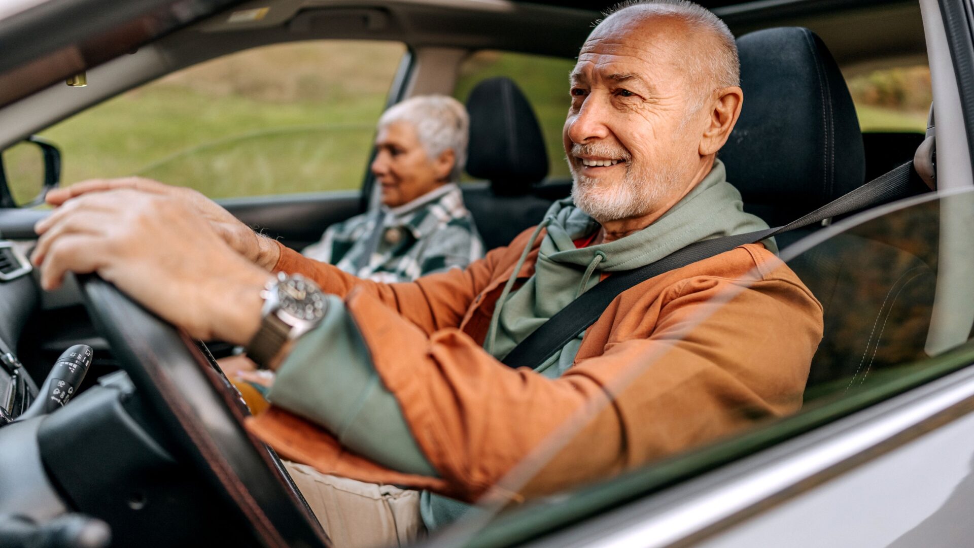 Mature couple driving in their car