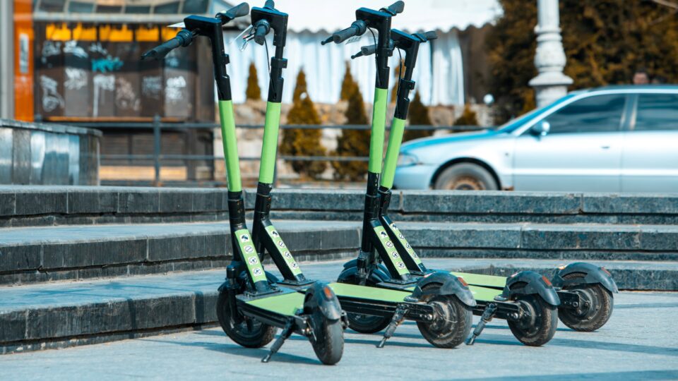 a collection of e-scooters parked on a city